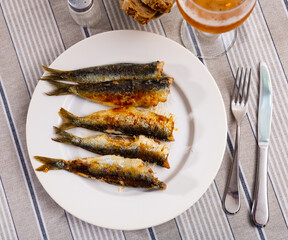 Fried atlantic sardine served on plate in restaurant