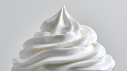 a large mound of whipped cream atop a cone shaped base, creating an appealing visual effect with the cream's fluffy texture