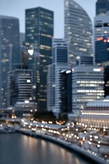 Fototapeta premium Defocused view of modern skyscrapers with evening city lights reflecting on the waterfront, creating a dreamy urban atmosphere
