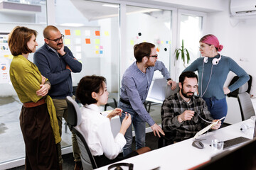 Group of businesspeople engaged in a collaborative discussion during a meeting in a modern office environment in the afternoon