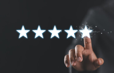 Businessman pointing five stars to increase the rating. Businessman pointing five star symbol to increase rating of company.
