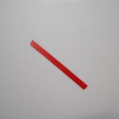 Close-up of a yellow plastic strap tied in a simple knot against a light surface. The image highlights its smooth texture, flexibility, and industrial design.