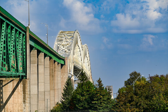 International Bridge connecting Sault Ste. Marie, Michigan and Ontario, viewed from the U.S. side with green steel girders and arched truss spans under a blue sky