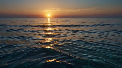 Fototapeta premium Ocean sunset with golden light reflecting on gentle waves.