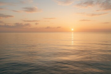 Naklejka premium Serene sunset over calm ocean gentle waves golden light soft clouds tranquil horizon