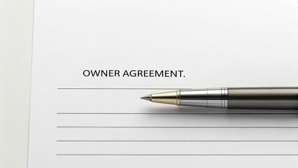 agreement owner management interest concept. Owner agreement document with a silver pen on a blank page.
