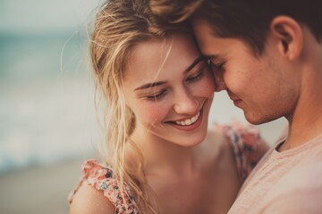 Obraz premium Charming young couple in love enjoying time at the beach holding each other