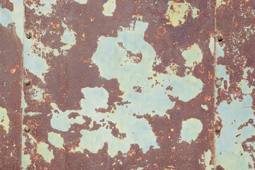 Background with rusty metal surface and old light green paint