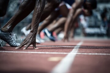 Runners launching from starting positions on the track