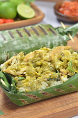 Grilled rice with shredded chicken and green chilies, wrapped in banana leaves, traditional Indonesian food