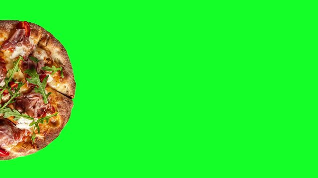 Prosciutto pizza with strachatella cheese, tomatoes and arugula leaves, top view, closeup object. Rotating on green background
