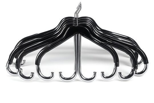Clothes Hangers Grouped Together on White. Black Plastic with Silver Metal Hooks