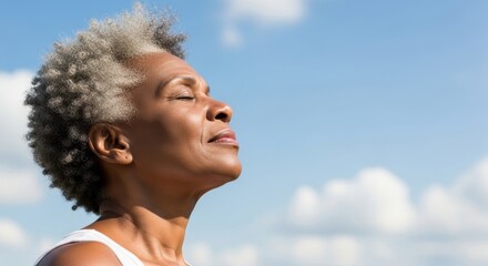 Senior Black Woman with eyes closed enjoying bright sunlight outdoors