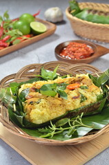 Grilled rice with stir fry chicken, wrapped in banana leaves, traditional Indonesian food