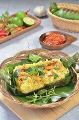 Grilled rice with stir fry chicken, wrapped in banana leaves, traditional Indonesian food