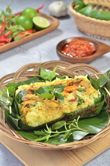 Grilled rice with stir fry chicken, wrapped in banana leaves, traditional Indonesian food