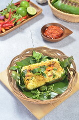 Grilled rice with stir fry chicken, wrapped in banana leaves, traditional Indonesian food