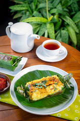 Grilled rice with stir fry chicken, wrapped in banana leaves, traditional Indonesian food