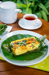 Grilled rice with stir fry chicken, wrapped in banana leaves, traditional Indonesian food