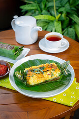 Grilled rice with stir fry chicken, wrapped in banana leaves, traditional Indonesian food