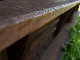 Wooden surface with a blurred green grass background. Perfect for nature, eco, or outdoor design mockups and product presentations