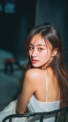 Elegant Portrait of a Serene Woman: Captured in a moment of contemplative beauty, a young woman exudes a gentle elegance. She gazes over her shoulder.