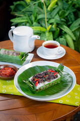 Grilled rice with stir-fried squid, wrapped in banana leaves, a traditional Indonesian dish