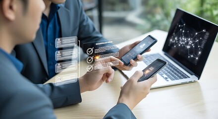 Business colleagues sharing digital information and networking using smartphones with a futuristic data interface overlay on the screen