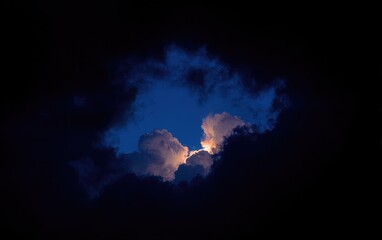 Dark sky with a cloud that is almost touching the ground
