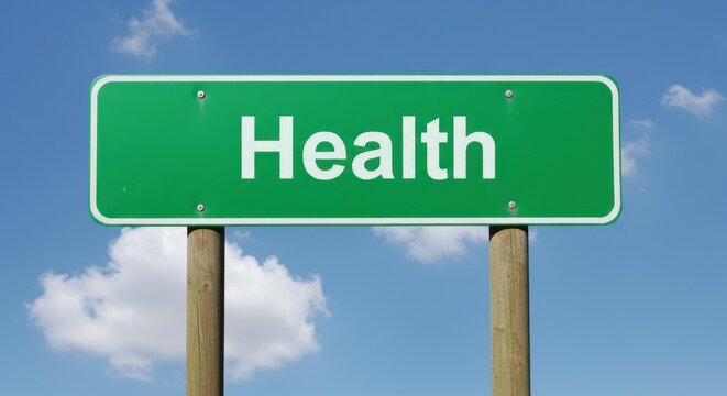 Green health information sign against a bright blue sky - Powered by Adobe