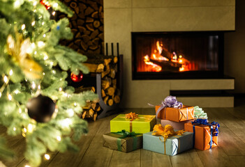 Beautiful Christmas interior with glowing fireplace, decorated tree, and colorful wrapped gifts on the floor, creating a cozy and festive holiday atmosphere at home.