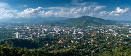 Obraz premium Panoramic View of Chiang Mai Skyline with Lush Greenery and Scenic Mountains Under a Blue Sky