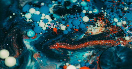 Oil background. Paint bubbles. Defocused orange blue purple color ink marble water round glitter texture flowing on acrylic art abstraction.
