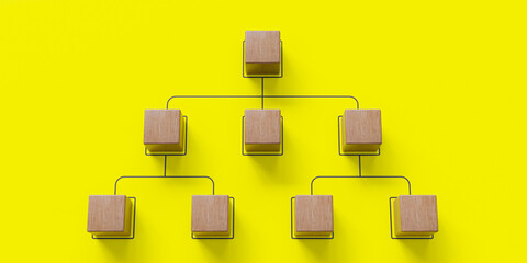 Company hierarchical organizational chart made of wooden cubes on a blue background, representing human resources management,