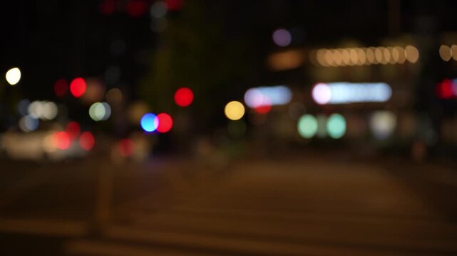 Night road lights blurred bokeh of cars in traffic on the road at night.