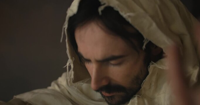 Jesus Christ in ambient light holding bread for communion, Passover, last supper for Christianity stock footage.
