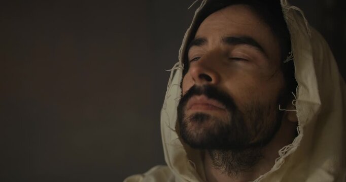 Closeup of the face of Jesus Christ praying in worship in deep contemplation for Christianity, easter, religion stock footage.