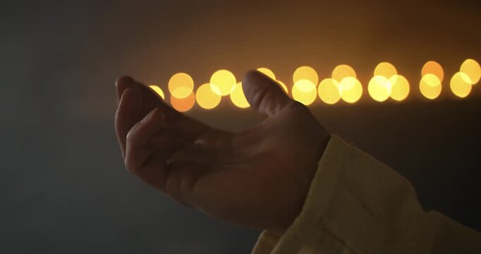 Closeup of hand lifted in prayer, worship, for Christianity stock footage.