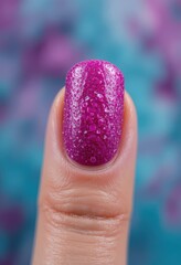 Pink Glittery Nail Art Close-Up on Finger with Abstract Background