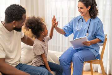 Fototapeta premium African girl high five with doctor after recovery, happy child leaving hospital healthy, pediatric care success, flu treatment completed, positive experience in children hospital, health insurance