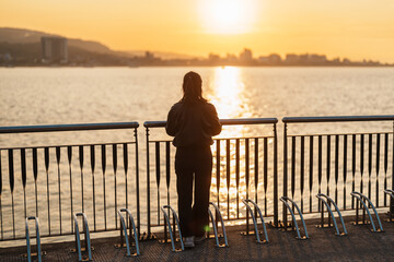Fototapeta premium woman traveler traveling in Taiwan, female Tourist sightseeing at Tamsui Old Street in sunset. Popular landmark for tourists attractions in Taipei, Taiwan