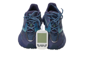 Athletic shoes with a glucose meter in front, isolated, PNG