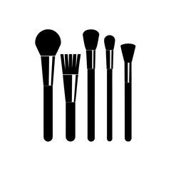 Five makeup brushes in black on transparent background