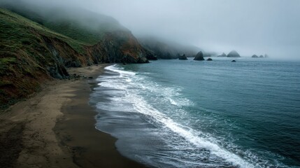 Fototapeta premium Serene Coastal Landscape with Waves and Fog Over Rocky Shoreline