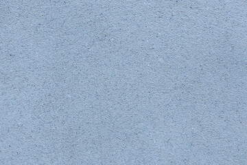 Close-up of rough, unpainted cement plaster wall texture. Neutral gray concrete surface background for construction, architecture, interior design, or industrial concepts.