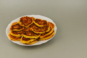 Delicious golden pancakes served on a white plate in a simple setting