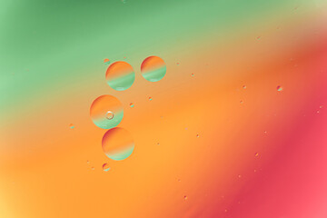 Green, Orange and Red Abstract Fluid Bubbles in Water Background
