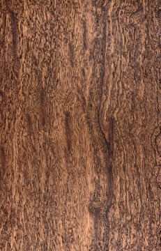 background is made of old wood. an old board. the texture of a rustic table. Sapele, sapelli, sapeli, mahogany, Entandrophragma, red wood, a place for a text or object