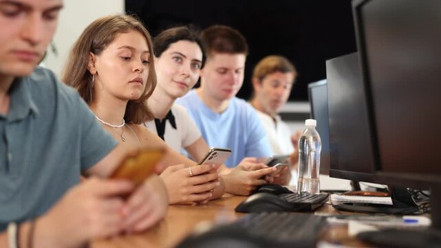 Student are engrossed in their mobile phones, working diligently on their tasks. High quality 4k footage