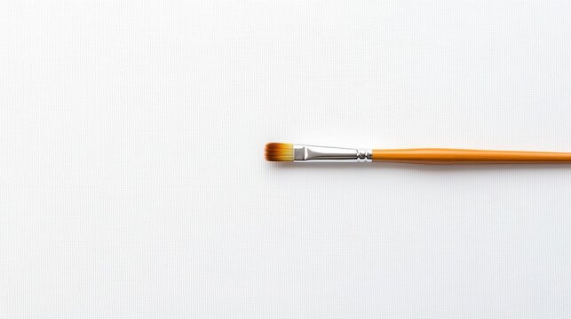 Paintbrush resting on white canvas, ready for creative work in art studio, inviting inspiration and imagination to flow freely